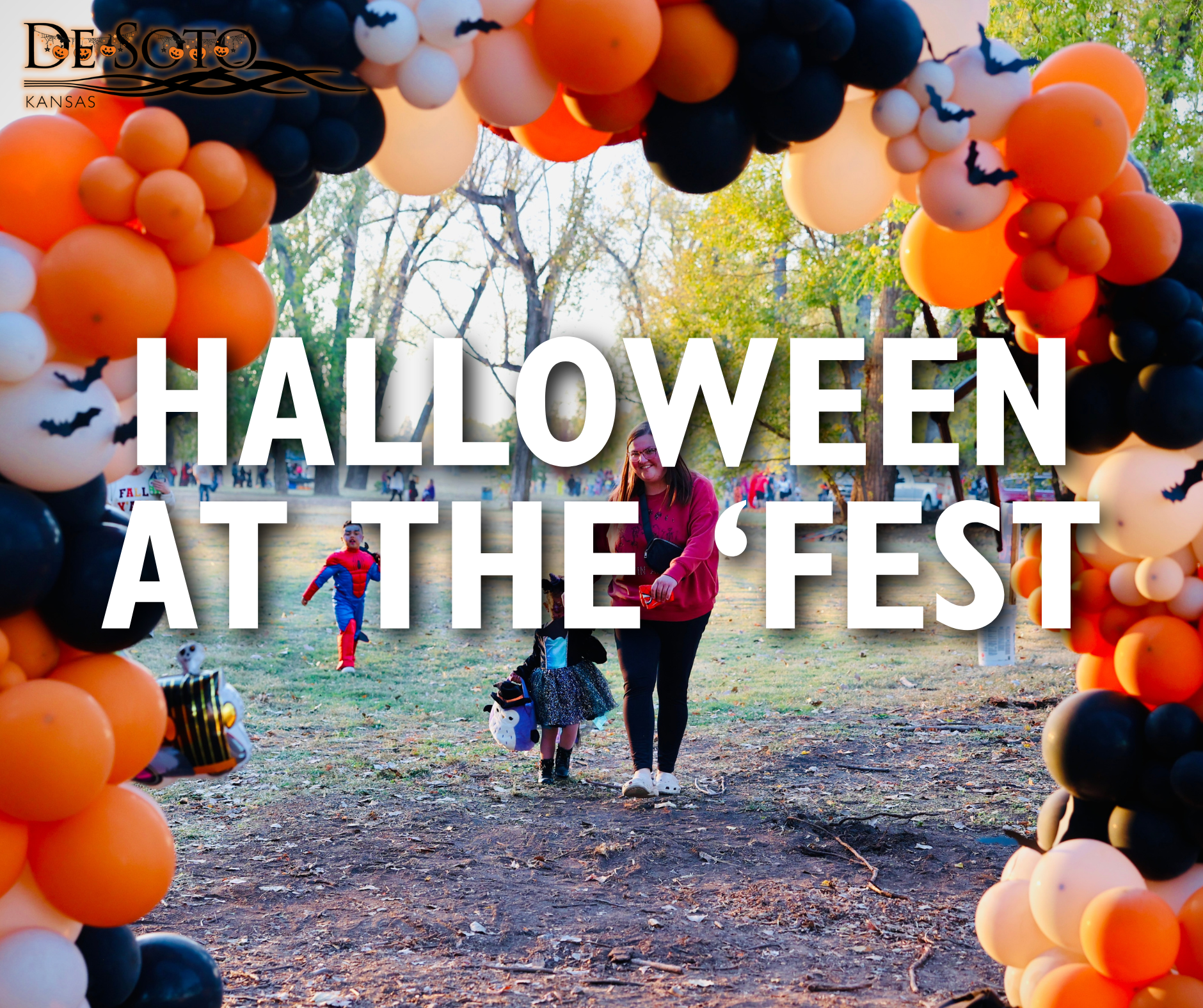 Guests walk under Halloween balloon arch at Riverfest Park as kids in costumes enter the trail!