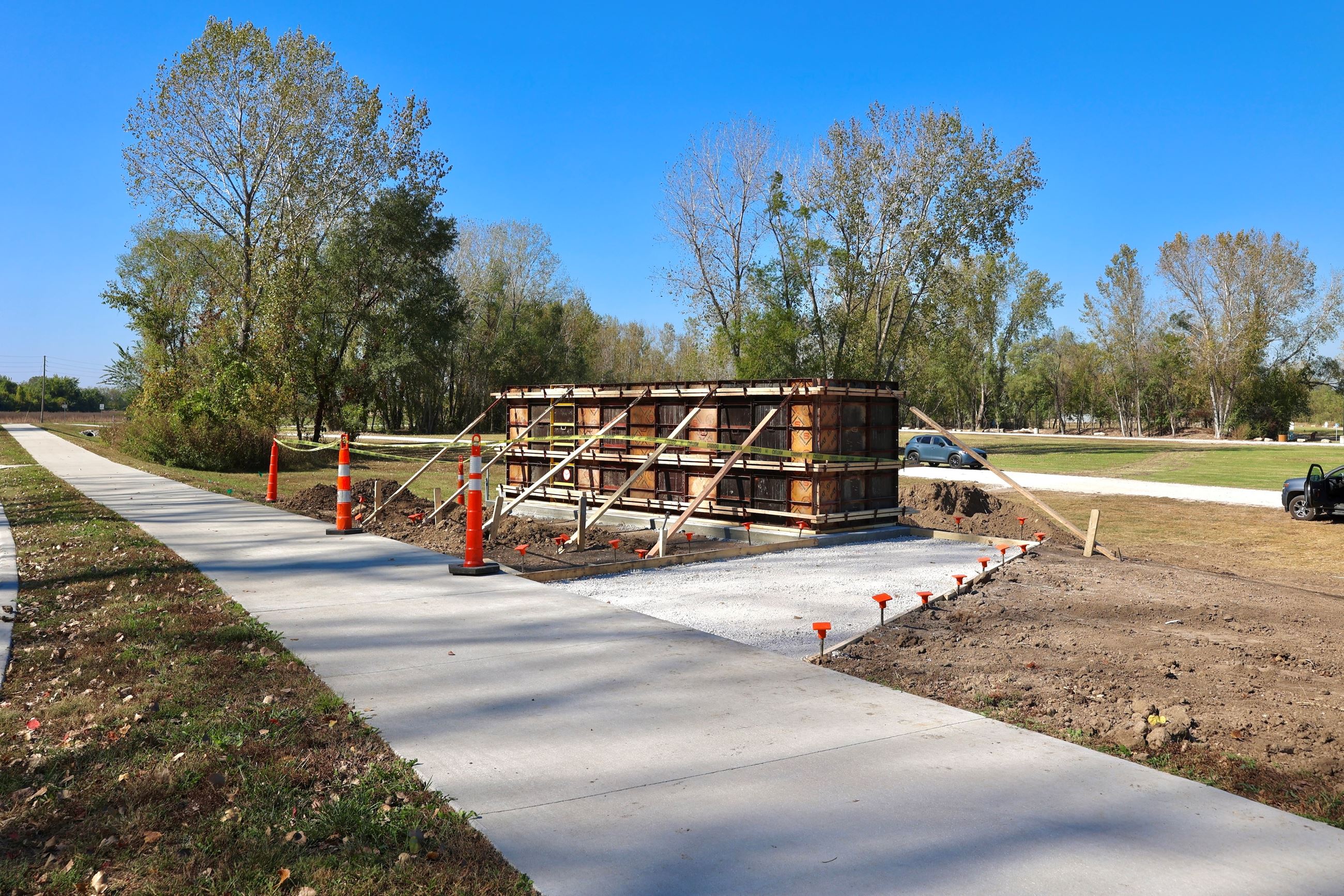 Monument sign construction underway sits next to the sidewalk along W 79th Street.